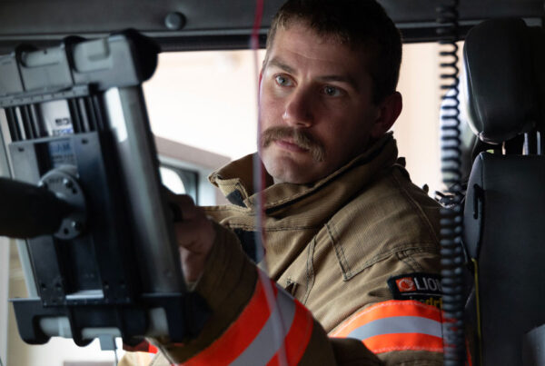 First responder engages with technology on tablet in his apparatus